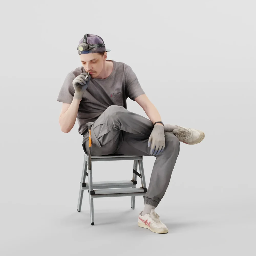 Worker In Gray Sits Smoking