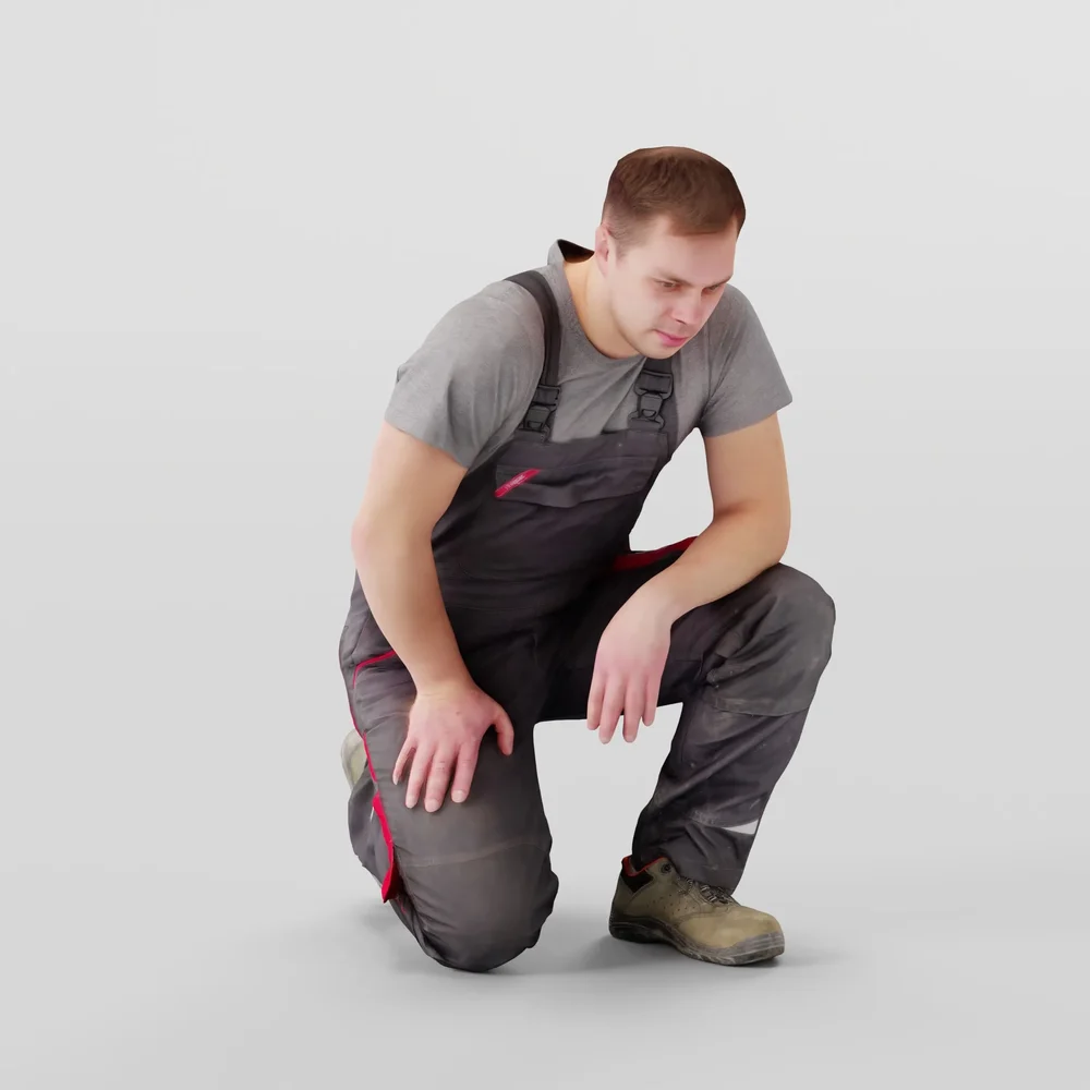 Foreman In Overalls Sitting On One Knee